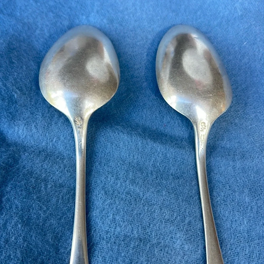Set of 2 antique spoons , stamped lion and sterling